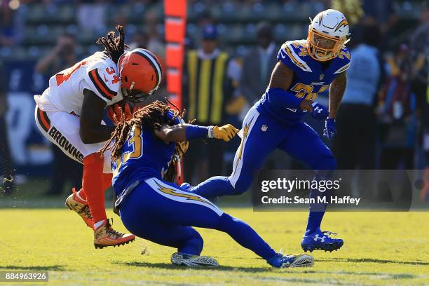 Isaiah Crowell of the Cleveland Browns is hits by Tre Boston of the Los Angeles Chargers during the first half of the game at StubHub Center on...