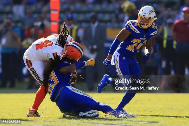 Isaiah Crowell of the Cleveland Browns is hits by Tre Boston of the Los Angeles Chargers during the first half of the game at StubHub Center on...