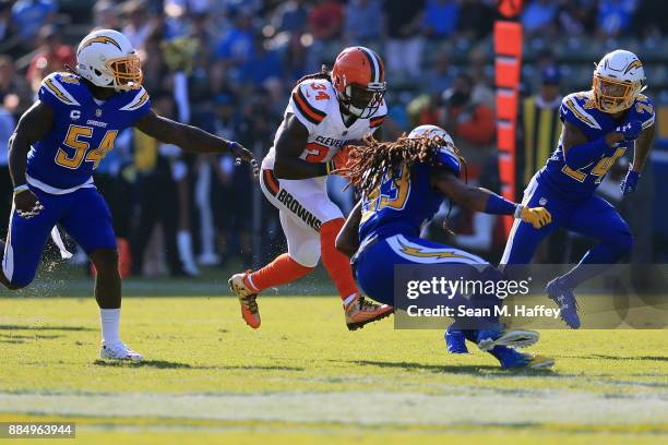 Isaiah Crowell of the Cleveland Browns is hits by Tre Boston of the Los Angeles Chargers during the first half of the game at StubHub Center on...