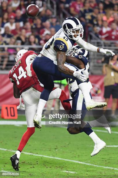 Strong safety John Johnson and free safety Lamarcus Joyner of the Los Angeles Rams break up a pass intended for wide receiver J.J. Nelson of the...