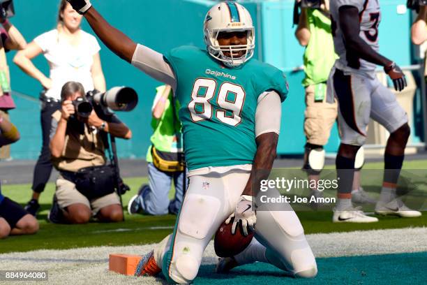 Tight end Julius Thomas of the Miami Dolphins riding the bucking bronco after a touchdown catch in the first half as the Broncos lose 35-9 at the...