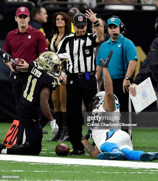 Carolina Panthers defensive end Julius Peppers reaches up toward a game official as he pleads his case after tackling New Orleans Saints wide...