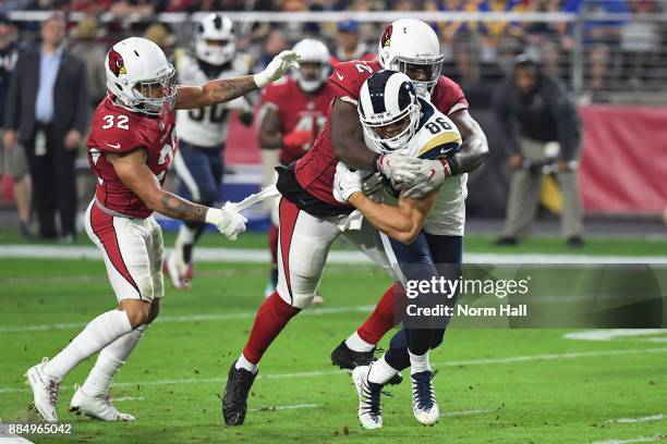 Defensive tackle Olsen Pierre and free safety Tyrann Mathieu of the Arizona Cardinals tackles tight end Derek Carrier of the Los Angeles Rams during...