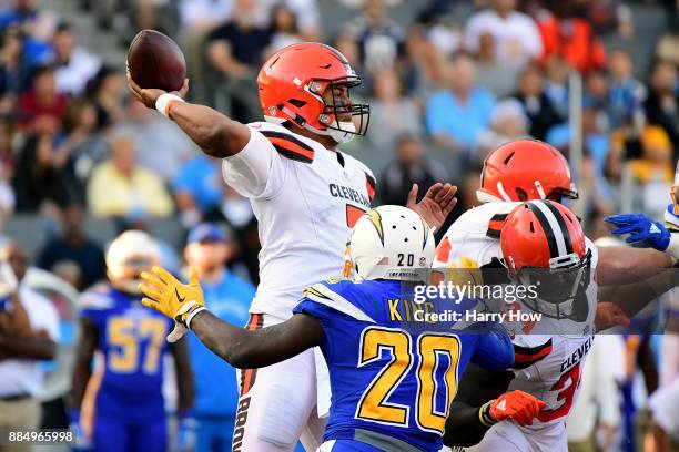 DeShone Kizer of the Cleveland Browns passes in the pocket as he is rushed by Desmond King of the Los Angeles Chargers during the third quarter of...