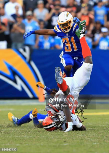 Tre Boston of the Los Angeles Chargers upends David Njoku of the Cleveland Browns on a short pass play during the second half of a game at StubHub...