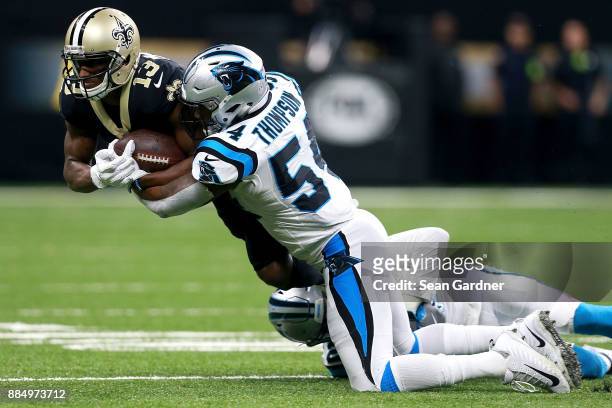 Michael Thomas of the New Orleans Saints is tackled by Shaq Green-Thompson of the Carolina Panthers during the second half of a NFL game at the...