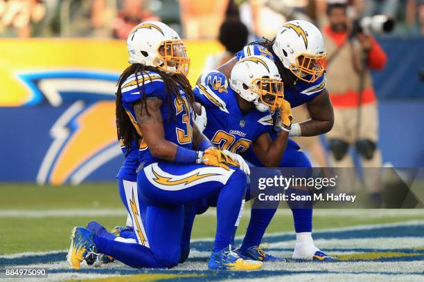 Darius Philon, Tre Boston and Desmond King of the Los Angeles Chargers react after a fumble recovery during the second half of a game against the...