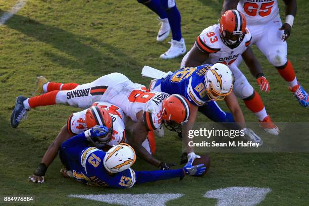 Trevon Coley and Christian Kirksey of the Cleveland Browns battle Keenan Allen and Hunter Henry of the Los Angeles Chargers for a fumble during the...