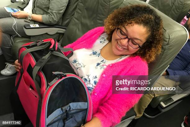 Cristina Sanchez sits aboard a flight to Orlando, Florida at a Luis Munoz Marin International Airport terminal in San Juan, Puerto Rico on November...