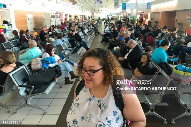 Cristina Sanchez waits to board a flight to Orlando, Florida at a Luis Munoz Marin International Airport terminal in San Juan, Puerto Rico on...
