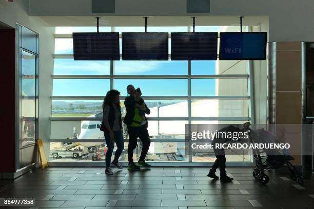 People are seen at a Luis Munoz Marin International Airport terminal in San Juan, Puerto Rico on November 30, 2017. On September 20 powerful Maria...