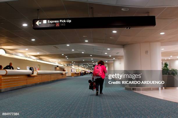 Cristina Sanchez leaves the Reception Center for Puerto Rican refugees set up at the Orlando International Airport after getting after obtaining...