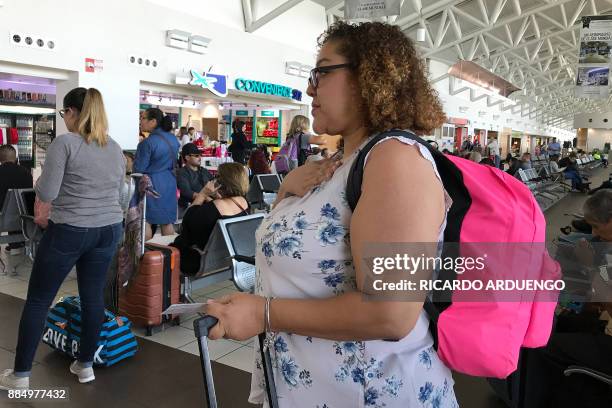 Cristina Sanchez waits to board a flight to Orlando, Florida at a Luis Munoz Marin International Airport terminal in San Juan, Puerto Rico on...