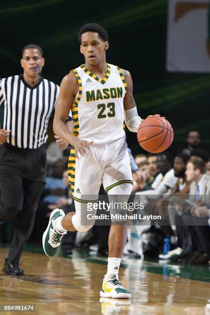 Javon Greene of the George Mason Patriots dribbles up court during a college basketball tournament against the George Mason Patriots at the Eagle...