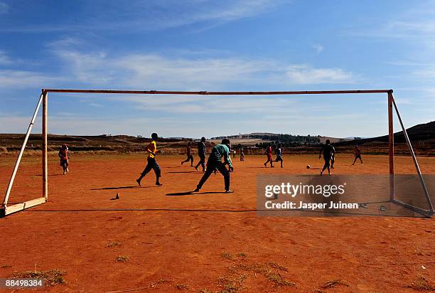 Kids enjoy a game of football on June 15, 2009 in Mogale City, South Africa. Football fever is gripping South Africa as the world's seven regional...