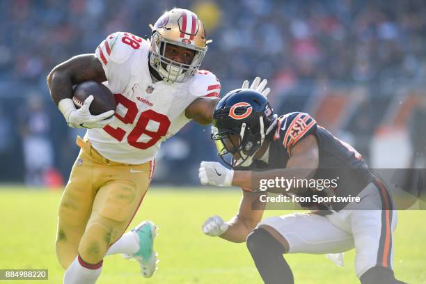 San Francisco 49ers running back Carlos Hyde gives Chicago Bears cornerback Kyle Fuller the stiff arm during the game between the Chicago Bears and...