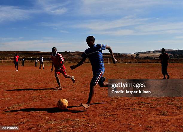 Kids enjoy a game of football on June 15, 2009 in Mogale City, South Africa. Football fever is gripping South Africa as the world's seven regional...