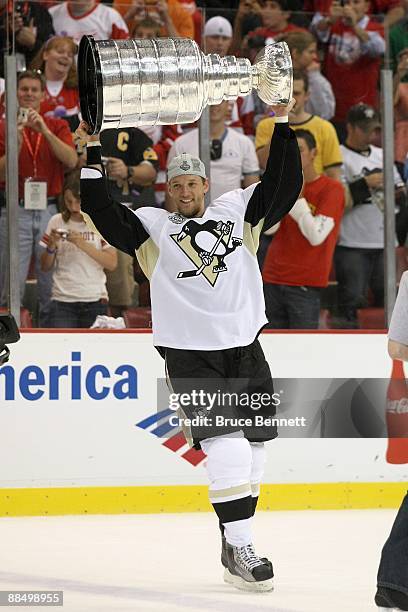 Mark Eaton of the Pittsburgh Penguins celebrates with the Stanley Cup after defeating the Detroit Red Wings by a score of 2-1 to win Game Seven and...