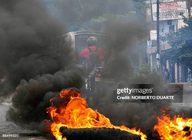 Tires burn in the streets of Fernando de la Mora, 10 km east of Asuncion, Paraguay on June 15 during a march called by the social movement "Sin...