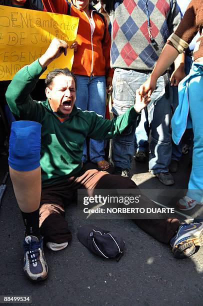 Member of the social movement "Sin Techo" shouts slogans against the government during march in Fernando de la Mora, 10 km east of Asuncion, Paraguay...