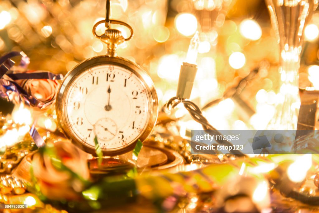 New Year's Eve holiday party, pocket watch, clock at midnight.