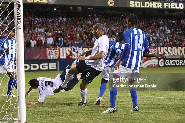 Carlos Bocanegra of the United States falls after heading the ball into the goal next to teammate Oguchi Onyewu in the 2nd half against Honduras as...