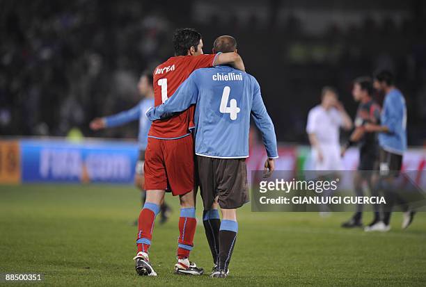 Italian goalkeeper Gianluigi Buffon hugs Italian defender Giorgio Chiellini after the Fifa Confederations Cup football match USA vs Italy on June 15,...