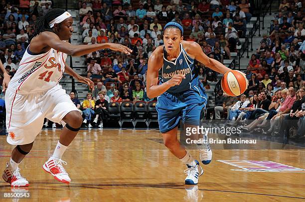 Marissa Coleman of the Washington Mystics drives the ball against Kerri Gardin of the Connecticut Sun during the WNBA game on June 6, 2009 at Mohegan...