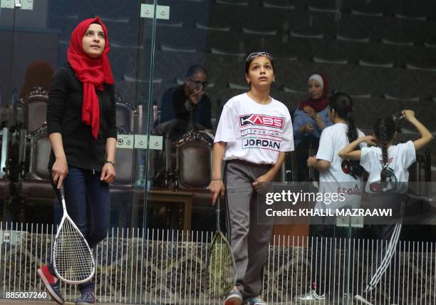 Raghda Nizar Yusef Hasriyeh , an 11-year-old Syrian refugee, plays squash during a training session on November 18 in the Jordanian capital Amman....