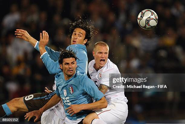 Luca Toni, Vincenzo Iaquinta and Jay DeMerit compete in the air for the ball during the Group B Confederations Cup match between the USA and Italy on...