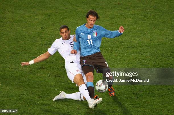 Alberto Gilardino of Italy is tackled by Oguchi Onyewu of USA during the FIFA Confederations Cup match between USA and Italy at Loftus Versfeld...