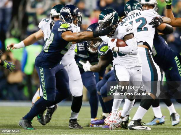 Middle linebacker Bobby Wagner of the Seattle Seahawks grabs at the facemask of running back Jay Ajayi of the Philadelphia Eagles in the second...