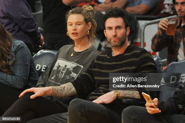 Singer Adam Levine and model Behati Prinsloo attend a basketball game between the Los Angeles Lakers and the Houston Rockets at Staples Center on...