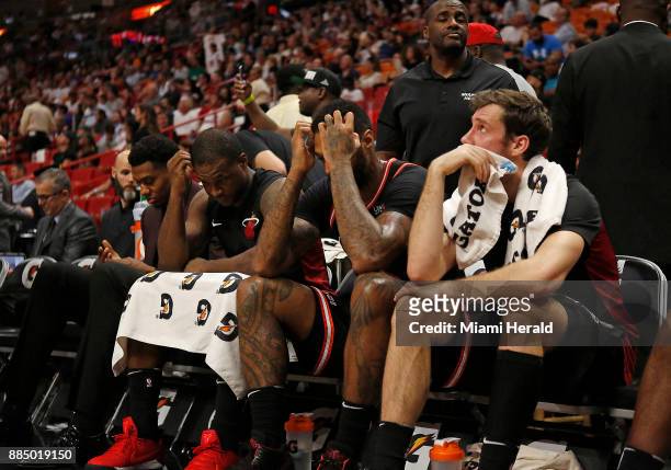 From left, Miami Heat players Hassan Whiteside, Dion Waiters, James Johnson and Goran Dragic look on from the bench during the fourth quarter against...