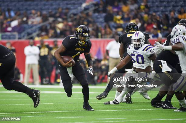 Grambling State Tigers quarterback Devante Kincade scrambles through a wide open hole enroute to a first half touchdown during the SWAC Championship...