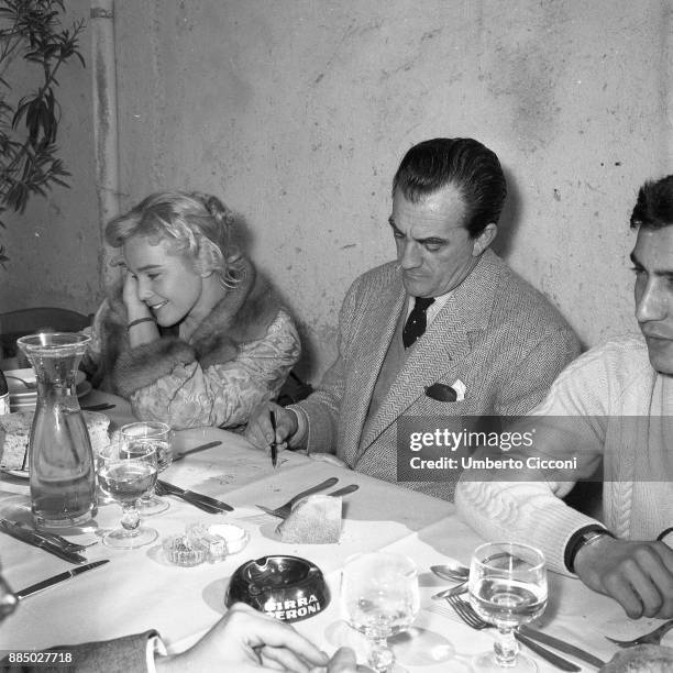 Actor Jean Marais, actress Maria Schell, director Luchino Visconti and other people during a lunch break while shooting the movie 'Le notti Bianche'...