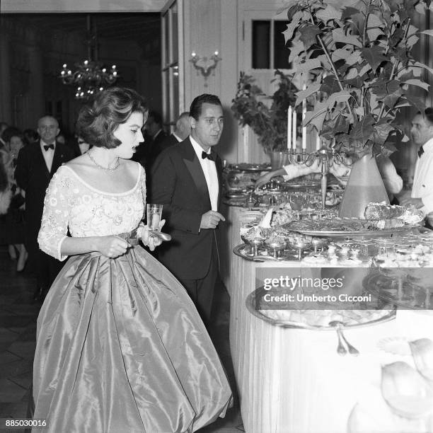 Actor Alberto Sordi and actress Silvana Mangano at the dinner party for the movie 'The Tempest', Italy 1958.