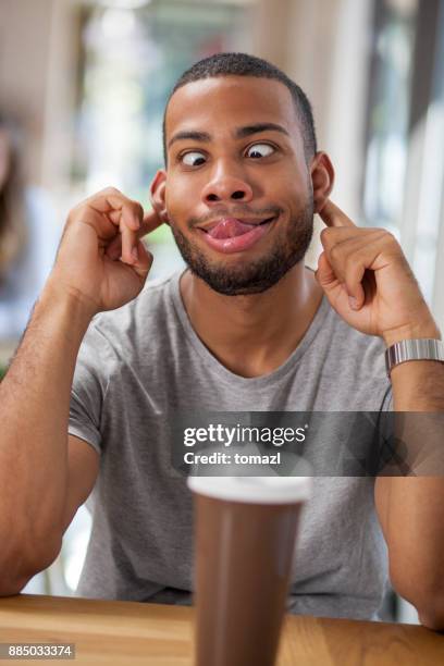young man making faces - playing footsie stock pictures, royalty-free photos & images