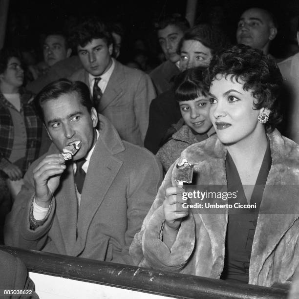 Italian actress Gina Lollobrigida eats an ice-cream with her husband and Milko Skofic, Rome 1955.