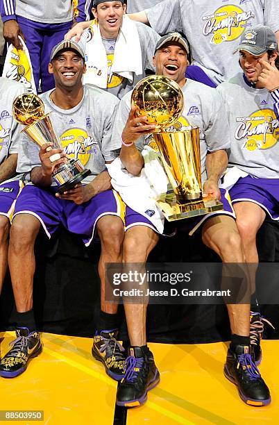 Finals MVP Kobe Bryant and Derek Fisher of the Los Angeles Lakers celebrate as they pose with their teammates for a team photo after their 99-86 win...