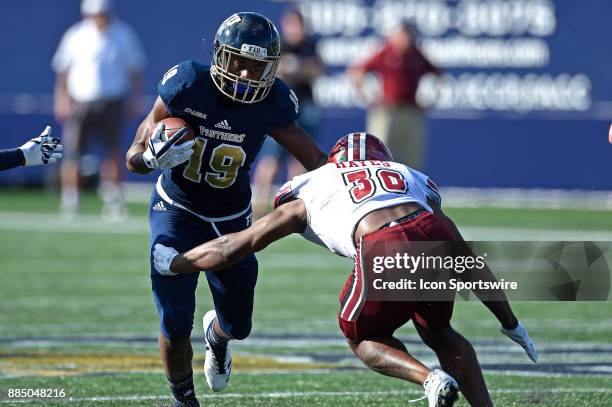 Wide receiver Shermar Thornton attempts to evade UMass safety Tyler Hayes after a reception in the fourth quarter as the FIU Golden Panthers defeated...