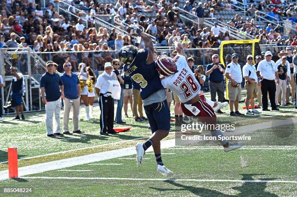 Wide receiver Bryce Singleton pulls in a reception for a touchdown in the fourth quarter despite the efforts of UMass cornerback Jackson Porter as...