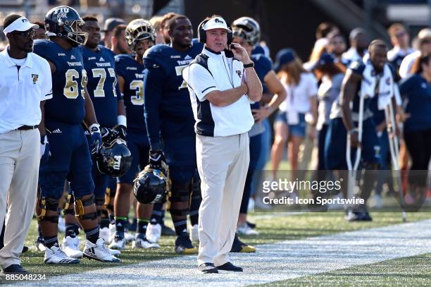 Football Head Coach Butch Davis keeps an eye on his players in the fourth quarter as the FIU Golden Panthers defeated the University of Massachusetts...