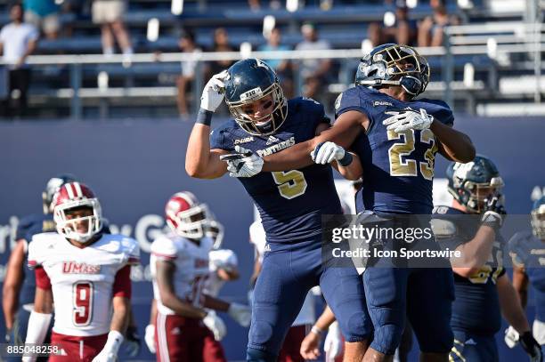 Wide receiver Julian Williams and running back Napoleon Maxwell celebrate Maxwell's touchdown in the fourth quarter as the FIU Golden Panthers...