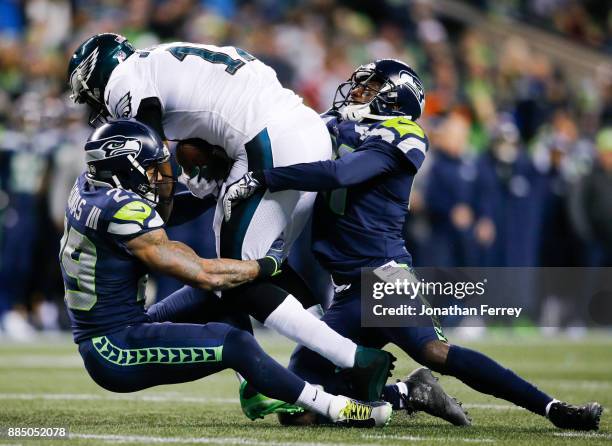 Wide receiver Alshon Jeffery of the Philadelphia Eagles gains 23 yards against free safety Earl Thomas of the Seattle Seahawks and Byron Maxwell in...