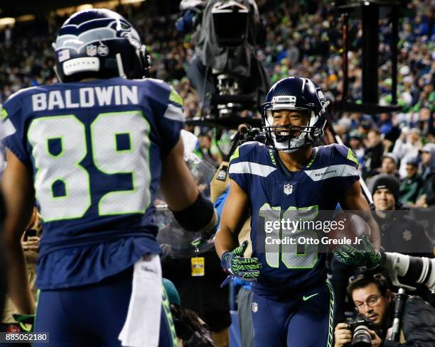 Wide receiver Tyler Lockett of the Seattle Seahawks celebrates his 1 yard touchdown with Doug Baldwin in the third quarter against the Philadelphia...