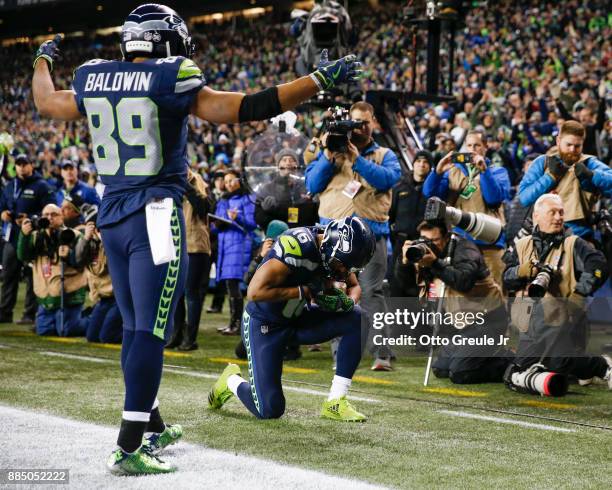 Wide receiver Doug Baldwin of the Seattle Seahawks comes over to congratulate wide receiver Tyler Lockett of the Seattle Seahawks on his 1 yard...
