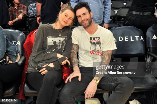 Singer Adam Levine and model Behati Prinsloo attend a basketball game between the Los Angeles Lakers and the Houston Rockets at Staples Center on...