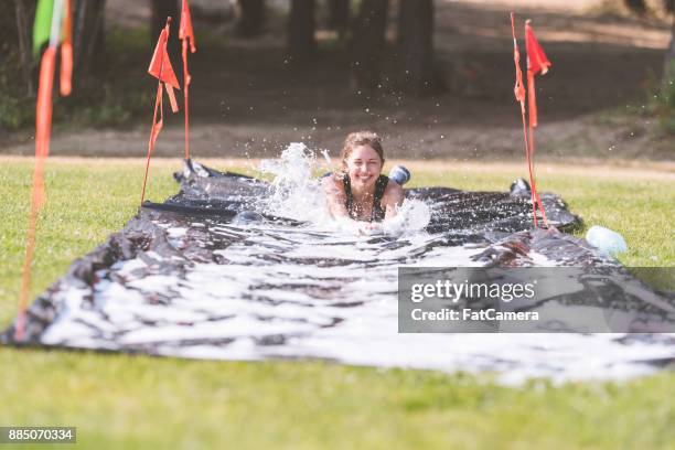 mud run fundraiser! - backyard water slide stock pictures, royalty-free photos & images