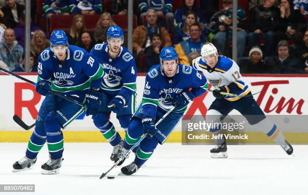 Jaden Schwartz of the St. Louis Blues and Brandon Sutter and Michael Del Zotto of the Vancouver Canucks look on as Derek Dorsett of the Vancouver...